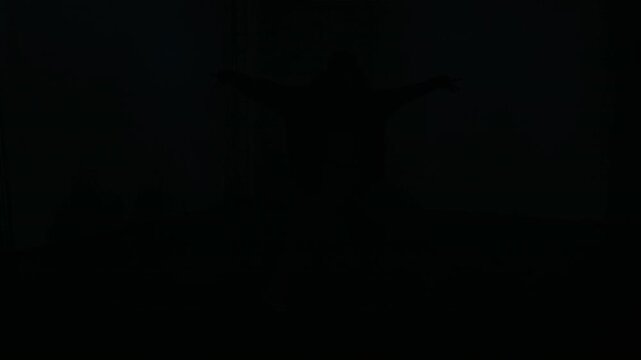 Front view wide angle shot of young woman emerging from darkness and dancing expressive hip hop freestyle under strobing lights in dark empty concrete bunker, cinematic underground vibe, copy space