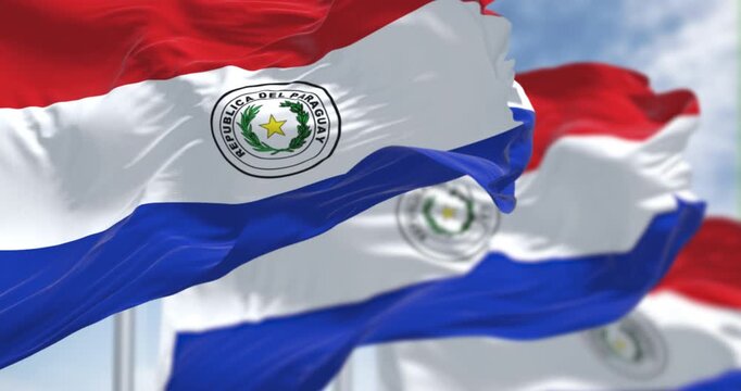 Paraguay national flags waving. Three equal horizontal bands of red, white and blue with an emblem centered in the white band. Seamless 3d render animation. Slow motion loop. Selective focus