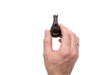 Hand holding dark wooden chess knight piece isolated © Kate