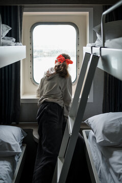A child looking through the window on a ferry in Ireland