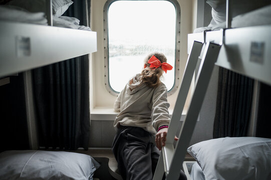 A child looking through the window on a ferry in Ireland