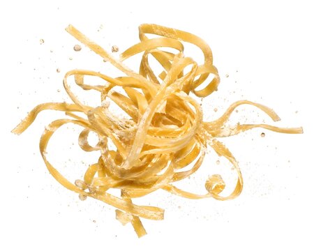 Flying raw fettuccine noodles with flour splash isolated on white background