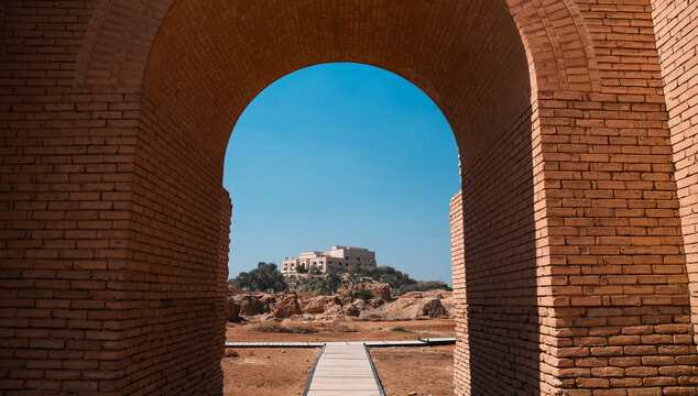 Majestic view of Saddam Hussein Palace framed by ancient archway in Iraq