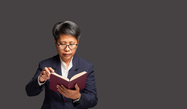 Businesswoman reading book with inclusive leadership concept