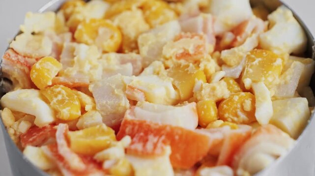 Crabmeat salad with eggs, canned corn, homemade mayonnaise, and ground pepper. High quality 4k footage