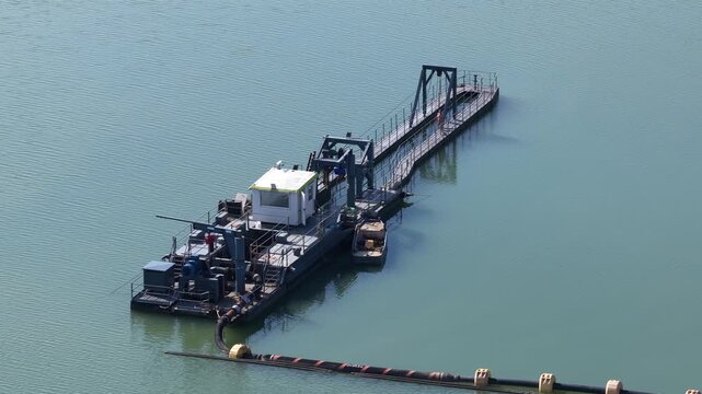 Industrial dredger vessel extracting sand from river