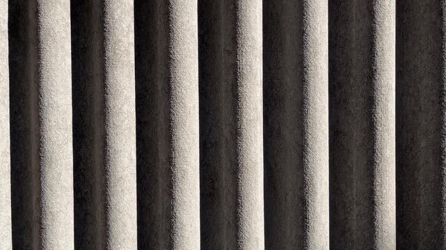 Corrugated asbestos roofing texture with vertical pattern and industrial surface in close-up architectural background.