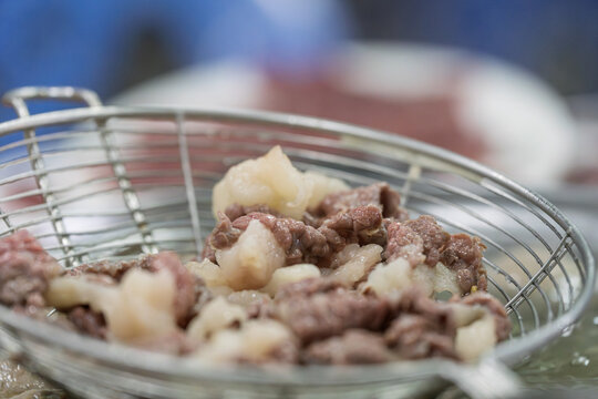 Fresh blanched beef hot pot ingredients in colander