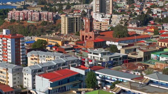 A telephoto bird's-eye view of the architecture of Baron Hill, with the restored San Francisco Church, on a sunny day, Valpara&iacute;so, Chile