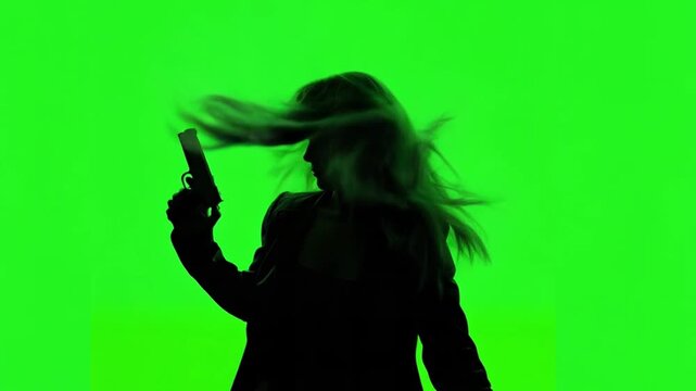 A woman is holding a gun against a green screen background with her hair moving for a crime, detective or mystery concept. Photo was animated with AI.