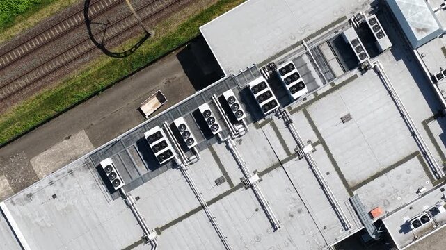 erial view of large scale data center rooftop HVAC cooling systems, showing colocation infrastructure, cloud computing, big data, machine learning and AI hardware technology.