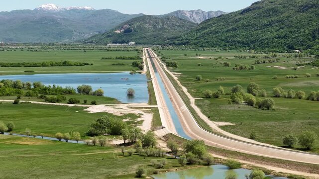 Niksic Montenegro, Drone Shot of Outflow and Canal Under Slano Lake and Green Landscape