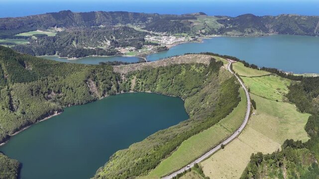 aerial of the twin lakes in the Sete Cidades volcanic crater, Sao Miguel, Azores. Drone flight over the lush green ridges and turquoise lagoons of the Atlantic archipelago