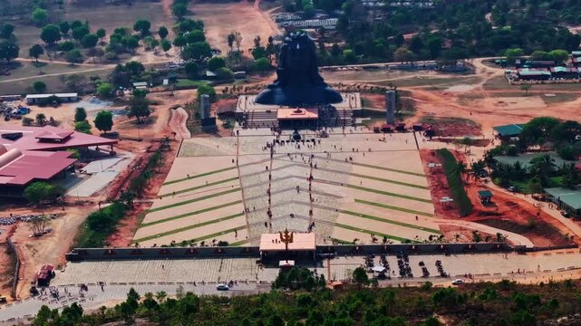 aerial view t of Adiyogi Shiva statue with Trishula, tourist and Shri Naagara Mantapa at Isha Foundation, Chikkaballapura, Bangalore, karnataka, india. day time, stable shot, drone shot, 4k.