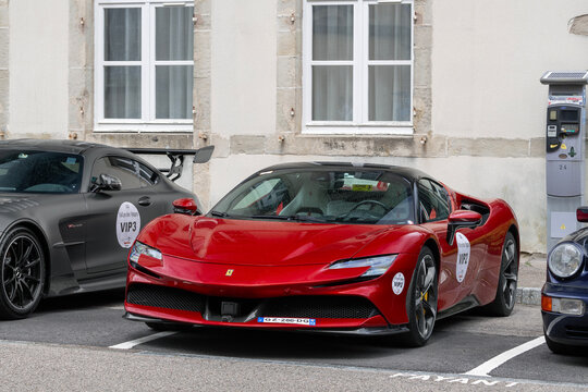 Remiremont, France - May 20th 2026 : View on a red Ferrari SF90 Spider parked on a street. The Ferrari SF90 Stradale is a mid-engine plug-in hybrid electric sports car.