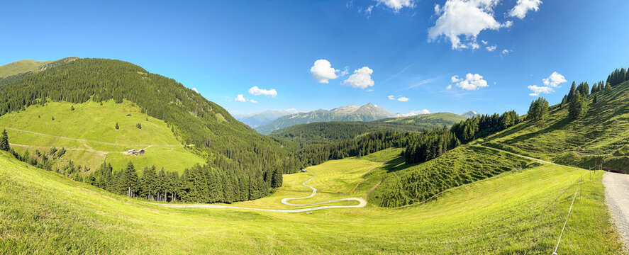Panoramic View Of Green Mountains And Meadows Under Blue Sky In K&ouml;nigsleiten Austria Tirol During Summer Season For Travel And Tourism