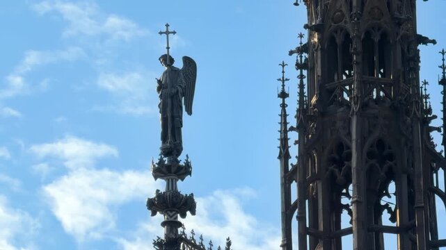 Close-up of the gothic spire and the angel statue at the top of the Sainte-Chapelle in Paris