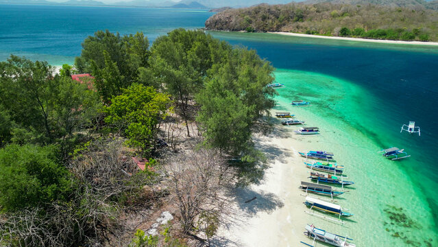 Gili Nanggu aerial drone view of turquoise lagoon and pristine beach on a sunny day Indonesia
