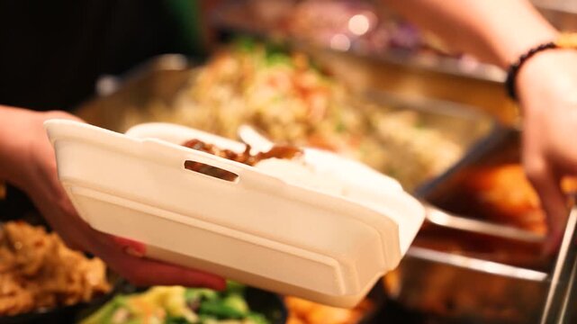 Street food packed into takeaway container ready for urban office lunch