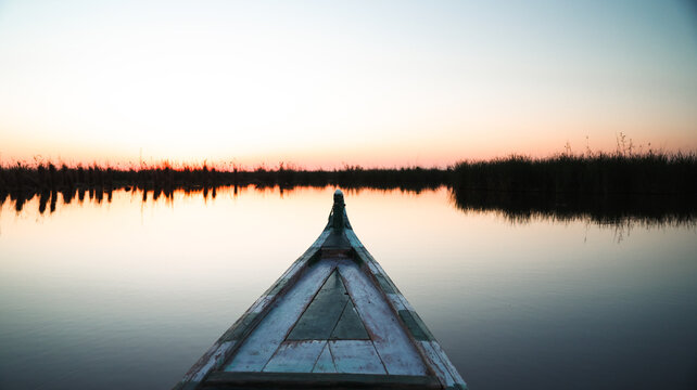 Sunset reflections over the Mesopotamian Marshes in Iraq from a traditional boat