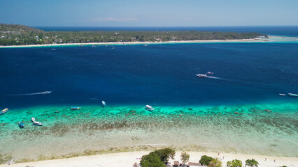Obraz premium Aerial drone view of Gili Meno tropical island on a bright sunny day with turquoise waters and white sand beaches Indonesia