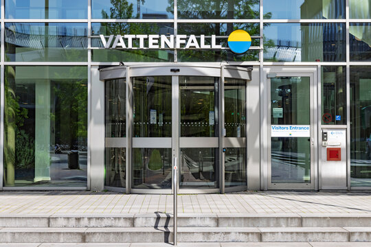 Amsterdam, Netherlands - May 23, 2026: Exterior view of the Vattenfall office building entrance featuring modern glass architecture, revolving doors, and company logo