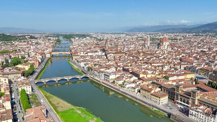 Fototapeta premium Drone aerial perspective Firenze Lungarni Arno River banks with Renaissance architecture colorful facades and Florence cityscape