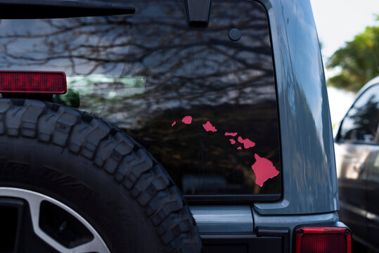 Pink Hawaii islands map decal on the rear window of a 4x4 vehicle