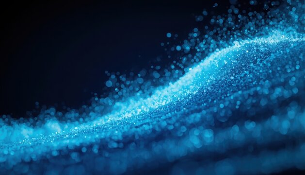 Abstract blue glowing particles in a flowing wave motion against a dark background with particle effect computer generated abstract science abstract technology abstract light abstract glow