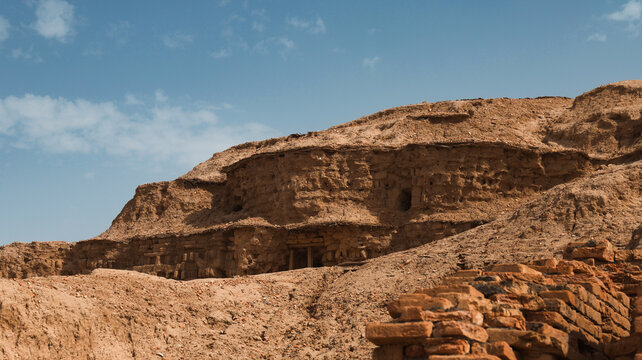 Ruins of ancient structures in Uruk Iraq under a clear blue sky