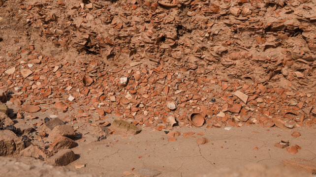 Exploration of ancient Uruk site revealing layers of terracotta fragments in Iraq