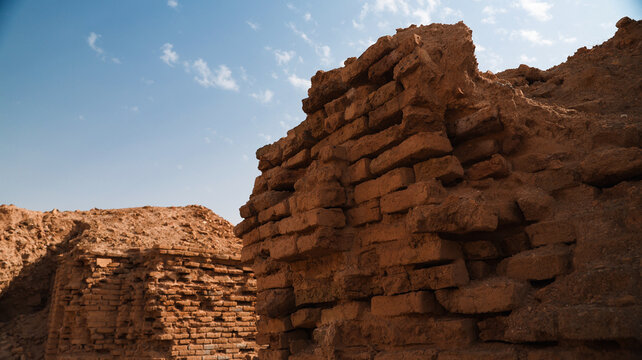 Exploring ancient ruins in Uruk Iraq showcasing historic brick structures under blue sky