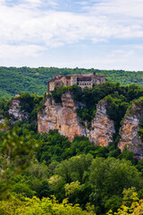 Fototapeta premium Bruniquel Castles at the top of a limestone cliff overlooking the Gorges de l'Aveyron and the Grésigne forest seen from the opposite slope