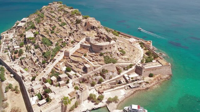 Aerial push in view of Spinalonga fortress island and turquoise sea