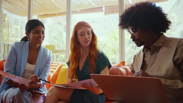 Multiethnic small group of businesspeople meeting in a coworking company office