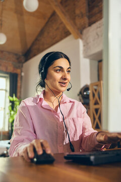 Female customer support operator working at computer in office. Concept of helpdesk service, client communication, call handling, online support, and customer care workflow.