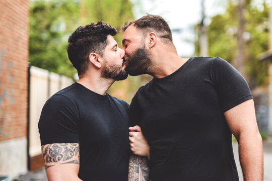 A Portrait of a happy gay couple outdoors in urban background
