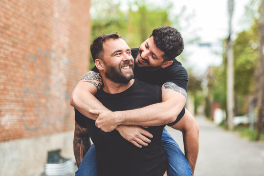 A Portrait of a happy gay couple outdoors in urban background