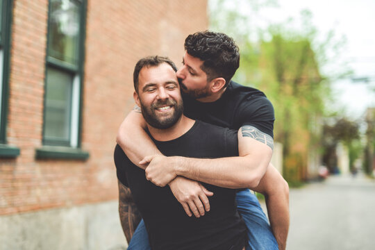 A Portrait of a happy gay couple outdoors in urban background