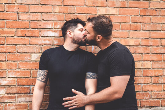 A Portrait of a happy gay couple outdoors in urban background