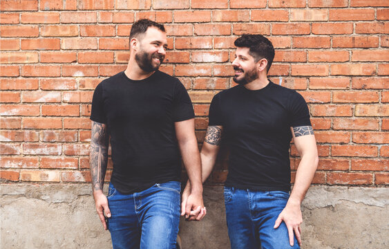 A Portrait of a happy gay couple outdoors in urban background