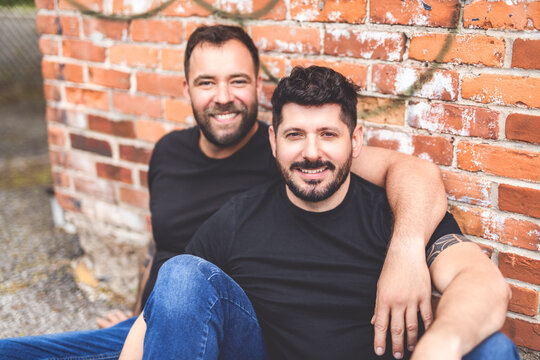 A Portrait of a happy gay couple outdoors in urban background