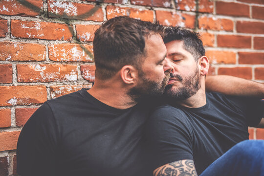 A Portrait of a happy gay couple outdoors in urban background