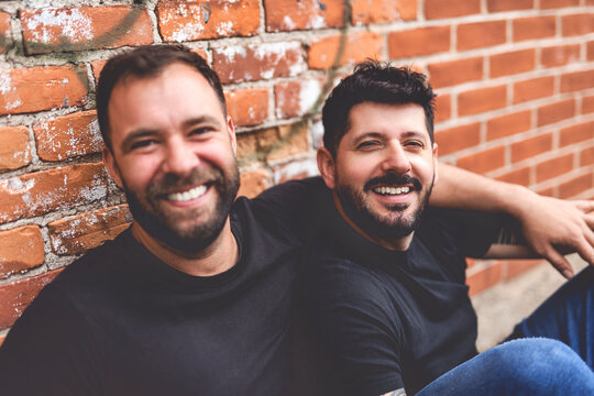 A Portrait of a happy gay couple outdoors in urban background