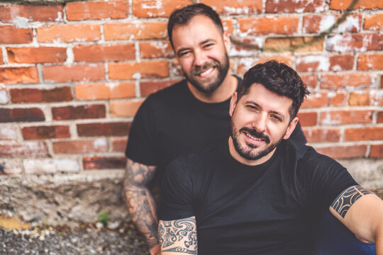 A Portrait of a happy gay couple outdoors in urban background