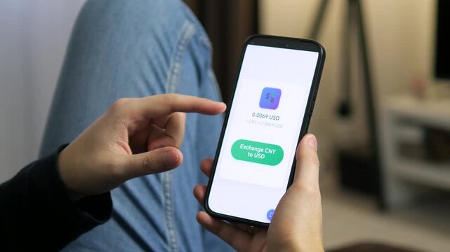 Instant currency exchange on the go. A person using a sleek mobile app to convert CNY to USD. Perfect for fintech, digital nomad lifestyle, and international banking content. High-quality visual for