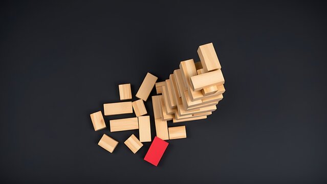 Partially collapsed tower of wooden blocks with a single red block apart.