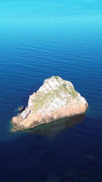 Crystal clear Mediterranean sea with Pan di Zucchero and Nebida rock