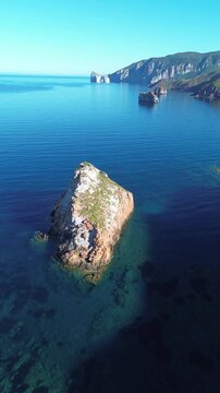 Crystal clear Mediterranean sea with Pan di Zucchero and Nebida rock