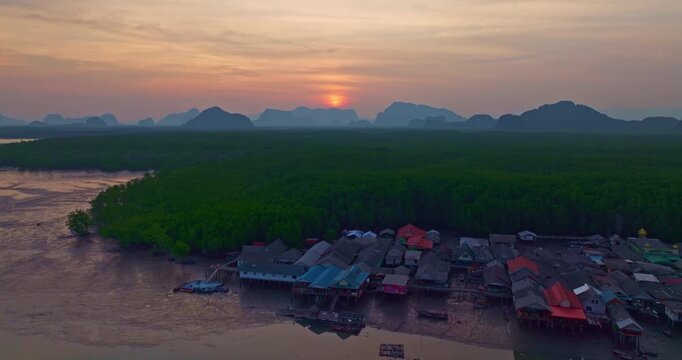 Sunset above Amazing a fishing village that lives on a small, isolated island. mangrove forests on the back. In front is a canal that leads to the sea. Landmark of seafood it is cheap and fresh.